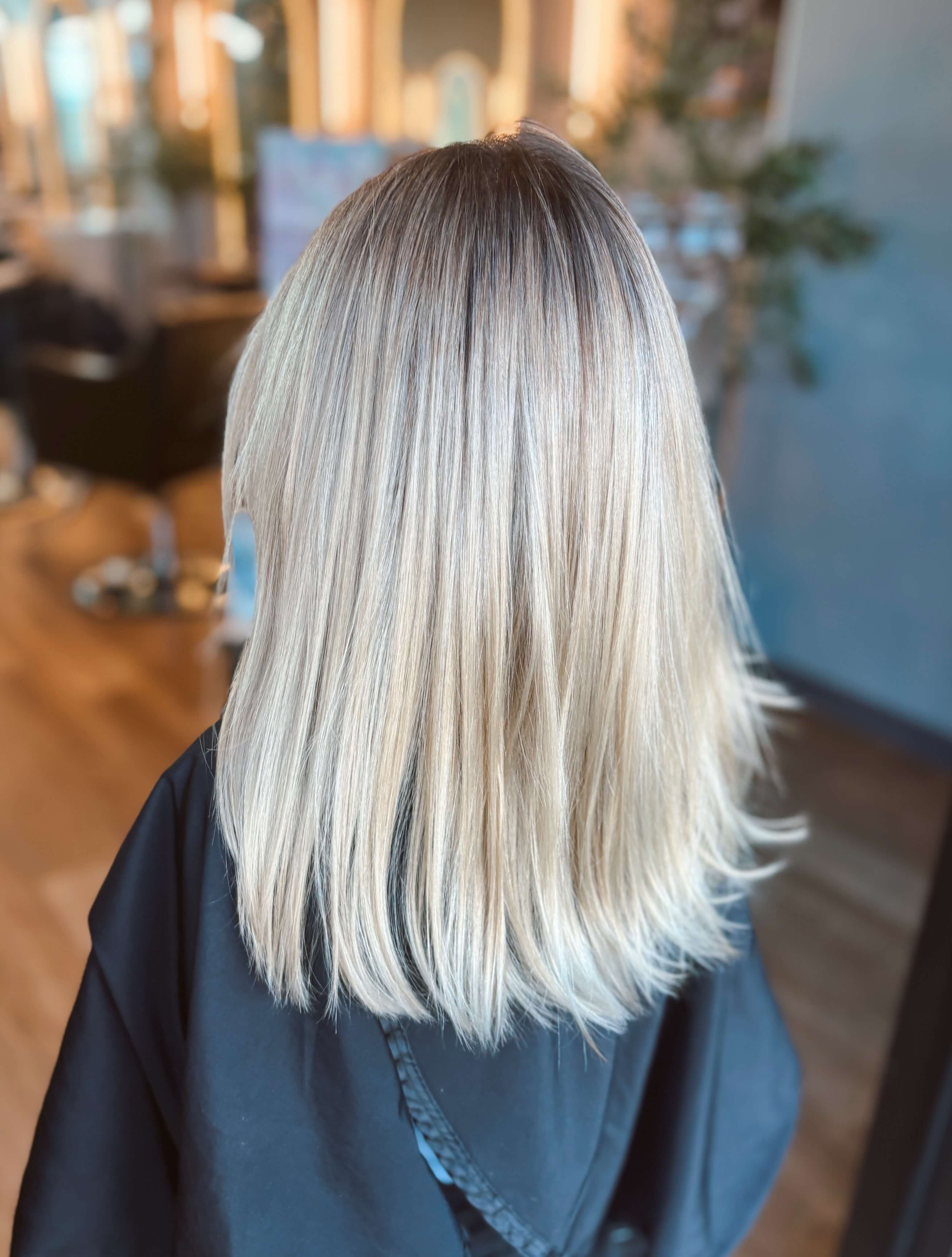 Sleek shoulder-length blonde with a soft root smudge and tone, by Karianna
